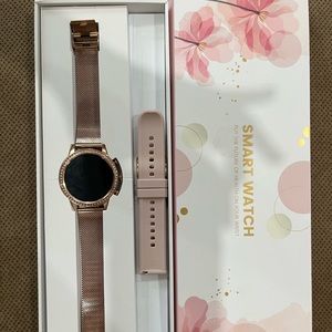 Rose Gold Smart Watch with extra light pink band. Charger included. Rarely used.
